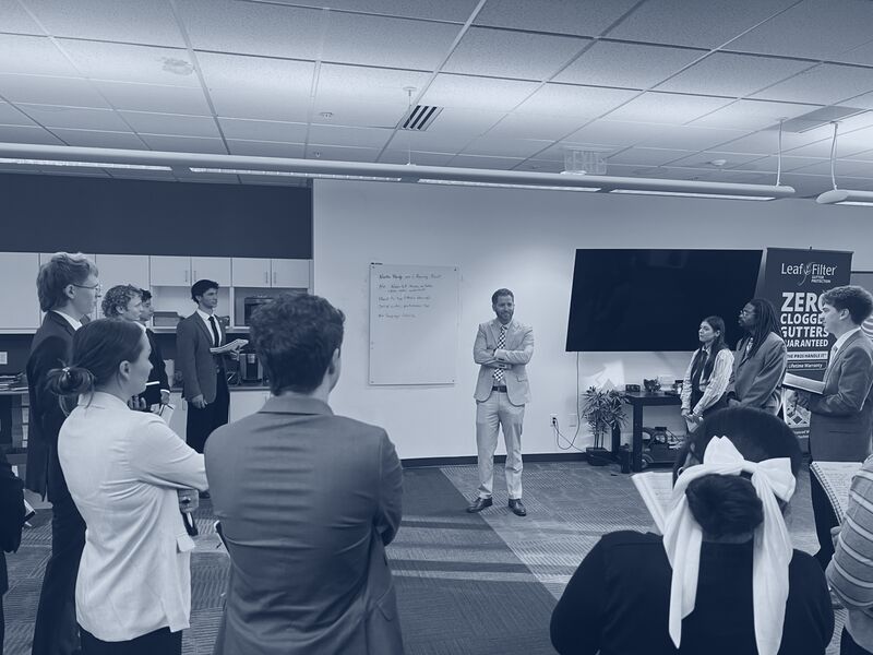An Icarus Acquisitions leader addressing team members during a coaching session