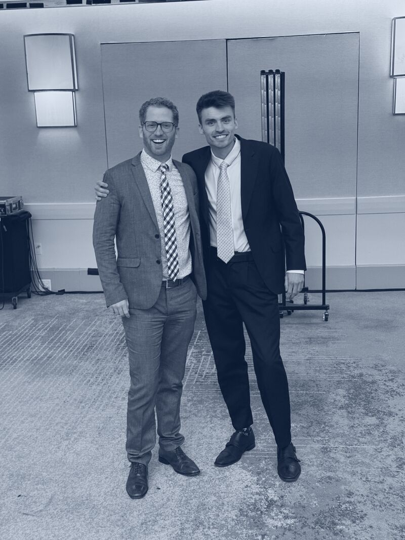 Two Icarus Acquisitions team members celebrating at an industry event
