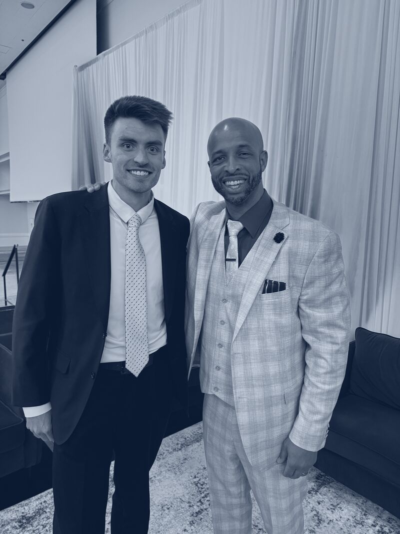 Two Icarus Acquisitions team members smiling together at an industry awards event