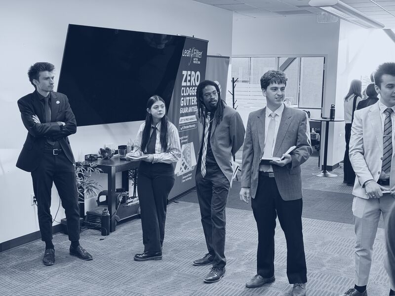 Icarus Acquisitions representatives in business attire during a client training session